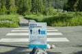 Crossing sign in the park. Covid-19 Social distance sign in Banff Notional park. Alberta, Canada 07.14.2020