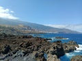 Nature\'s artistry on display as rugged rocks extend into the vast sea