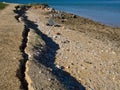 Erosion in the coastal zone. Ground cracking and sliding into the sea.