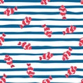 Nature seamless pattern with pink bright clown fish ornament. Blue and white striped background