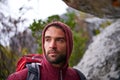 Nature, serious and man on rock, backpack and thinking in mountain or stone for adventure. Hiking, earth and male person Royalty Free Stock Photo