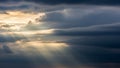 Dramatic Sunbeams Breaking Through Dark Storm Clouds Keywords: sunbeams, light rays, clouds, sky, dramatic, storm Royalty Free Stock Photo