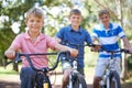 Nature, smile and portrait of kids on bicycles riding in outdoor field, park or forest for exercise. Happy, cycling and