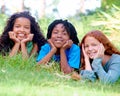 Nature, smile and portrait of kids on grass in outdoor park, field or garden together. Happy, diversity and group of Royalty Free Stock Photo