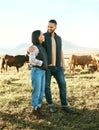 Nature, summer and couple in field with cows, happy dairy farmer on grass with animals. Sustainability, farming and man