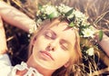 Happy woman in wreath of flowers lying on straw Royalty Free Stock Photo