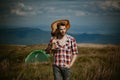 Nature, summer, youth culture and people concept. Young hippie man hold guitar on nature outdoors. Hipster guy relaxing