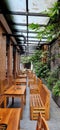 A nature-themed restaurant that uses a mix of stone, plants, and wood for its furniture with a canopy.