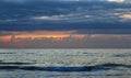 Nature in twilight period which including of sunrise over sea. Summer beach with blue water and purple sky at the sunset Royalty Free Stock Photo