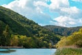 Nature. View of the beautiful landscape with green forests, mountains, lake and blue sky with clouds. Copy Royalty Free Stock Photo