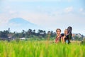 Happy mother hold little baby in hiking backpack carrier