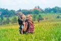 Happy mother hold little baby in hiking backpack carrier