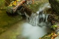 Nature waterfall at mountain river cascade. Colorful green mossy rocks, waterfall and cascade. Nature background. Royalty Free Stock Photo