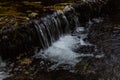 Nature waterfall at mountain river cascade. Colorful green mossy rocks, waterfall and cascade. Nature background. Royalty Free Stock Photo