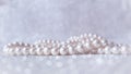 Nature white pearl beads on sparkling background Royalty Free Stock Photo