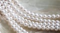 Nature white string of pearls on marble background in soft focus, with highlights Royalty Free Stock Photo