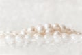 Nature white string of pearls on a sparkling background in soft focus, with highlights Royalty Free Stock Photo