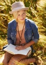 Nature woman, field and relax with book journal about natural wellness, stress relief or creative story on spring lawn