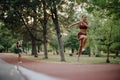 Nature& x27;s Fitness: Athletic Girls Jogging in the Green Park