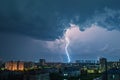 Natures fury Lightning bolt strikes over the city during thunderstorm Royalty Free Stock Photo