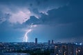 Natures fury Lightning bolt strikes over the city during thunderstorm Royalty Free Stock Photo