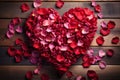 Natures love heart crafted from rose petals on wood Royalty Free Stock Photo