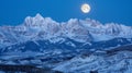 Natures own artwork as the moons shimmering light dances across the sharp peaks and valleys of the snowcovered mountain