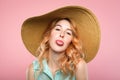 Naughtiness antics frolicking girl sunhat tongue Royalty Free Stock Photo