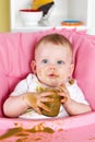 Naughty baby girl making a mess while eating