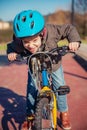 Naughty boy with defiant gesture over his bike