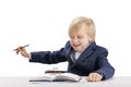 Naughty boy doing his homework. Child in school uniform at table. Schoolboy is fooling around Royalty Free Stock Photo