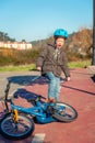 Naughty boy screaming and kicking his bike on