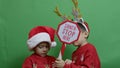 Naughty brothers inviting santa to come. Dancing and grabbing the sign