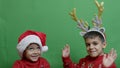 Naughty brothers inviting santa to come. Dancing and grabbing the sign