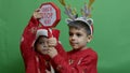 Naughty brothers inviting santa to come. Dancing and grabbing the sign