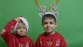 Naughty brothers inviting santa to come. Dancing and making funny face expressions