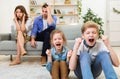 Naughty Children Misbehaving Screaming Sitting Near Exhausted Parents At Home Royalty Free Stock Photo