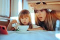 Naughty Daughter Playing with the Coffee Cup Exasperating Mom