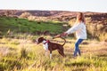 Naughty dog pulling on a leash, happy woman  not controlling the dog Royalty Free Stock Photo