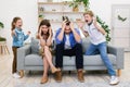 Naughty Kids Shouting Loudly Standing Near Tired Parents At Home