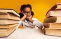 Naughty Schoolgirl Sitting At Books Bored Of Homework, Yellow Background Royalty Free Stock Photo