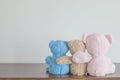 Naughty teddy bear is hanging on the pink rope,Everywhere the doll is happyFriendship - three teddy bears holding in one`s arms Royalty Free Stock Photo