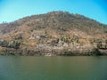 Naukuchiatal lake with a green hill above Royalty Free Stock Photo