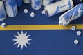 Nauru flag and few used aerosol spray cans for graffiti painting. Street art culture concept