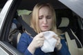 Nausea during a car trip. A blonde woman suffers from kinetosis. The concept of motion sickness in diseases of the transport and