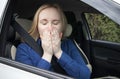 Nausea during a car trip. A blonde woman suffers from kinetosis. The concept of motion sickness in diseases of the transport and Royalty Free Stock Photo