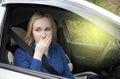 Nausea during a car trip. A blonde woman suffers from kinetosis. The concept of motion sickness in diseases of the transport and Royalty Free Stock Photo