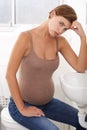 Nausea, pregnant woman and morning sickness in portrait, bathroom and uncomfortable person. Exhausted, moody and