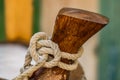 Nautical background of knotted rope on wood cleat Royalty Free Stock Photo