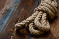 Nautical background. Nautical rope knot on a wooden desk. Royalty Free Stock Photo